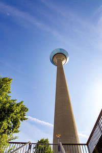 Low angle view of communications tower against sky