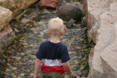 Boy standing on rock