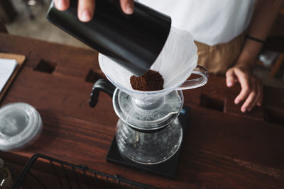 Barista dripping coffee and slow coffee wooden bar style