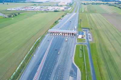 Car traffic transportation on multiple lanes highway road and toll collection gate, drone aerial 