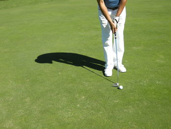 Low section of man playing golf