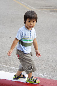 Portrait of cute boy walking on street