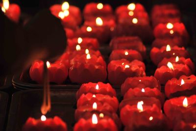 Close-up of lit candles in temple