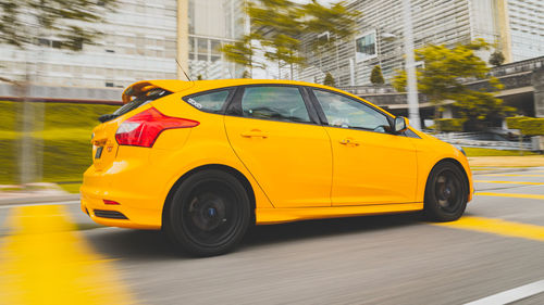 Yellow car on city street