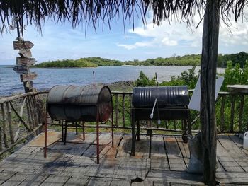 Gazebo by lake against sky