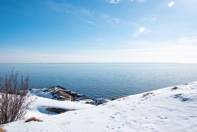 Scenic view of sea against sky during winter