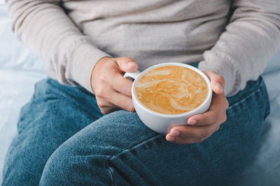 Midsection of woman holding drink