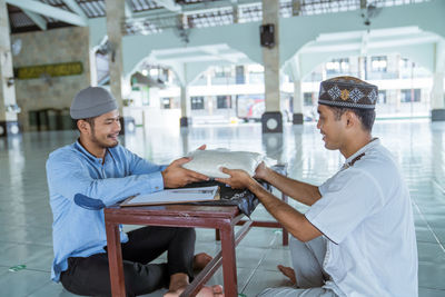 Man receiving rice from mosque