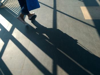 Low section of woman walking on footpath