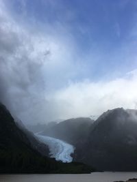 Scenic view of lake and mountains against sky