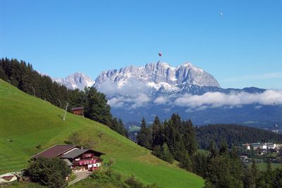 Scenic view of mountains against clear blue sky