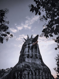 Low angle view of rock formation against sky