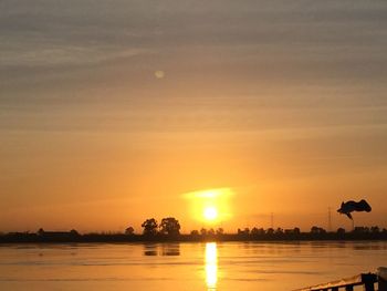 Scenic view of lake against sky during sunset