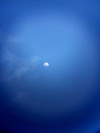 Scenic view of moon against blue sky