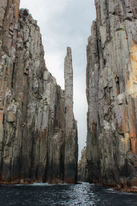 Panoramic view of sea against sky with rockclimber