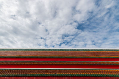 Low angle view of multi colored roof and building against sky