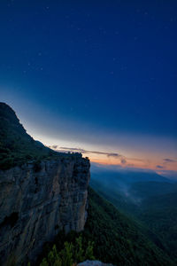 Scenic view of landscape against blue sky at night