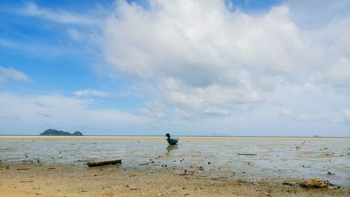 Boat moored on sea against sky