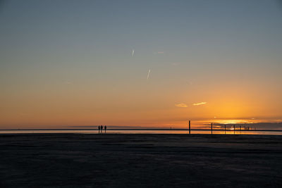 Scenic view of beach against sky during sunset