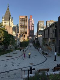 People in city against clear sky