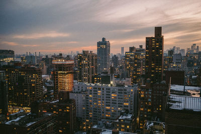 High angle view of illuminated buildings against sky during sunset