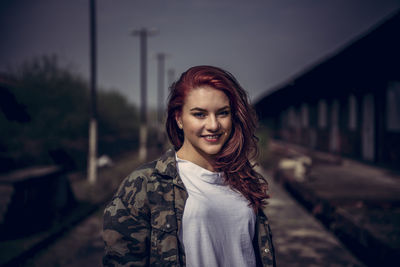 Portrait of smiling young woman standing outdoors