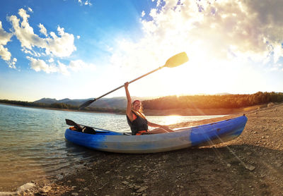 Man in boat on sea against sky