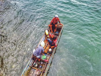 High angle view of people sitting on boat in river