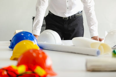 Midsection of man working on table