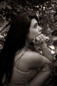 Portrait of young woman looking away outdoors
