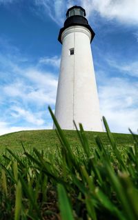 Low angle view of lighthouse on field against sky