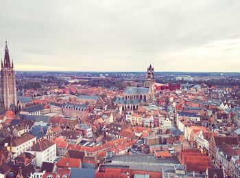 Cityscape against cloudy sky