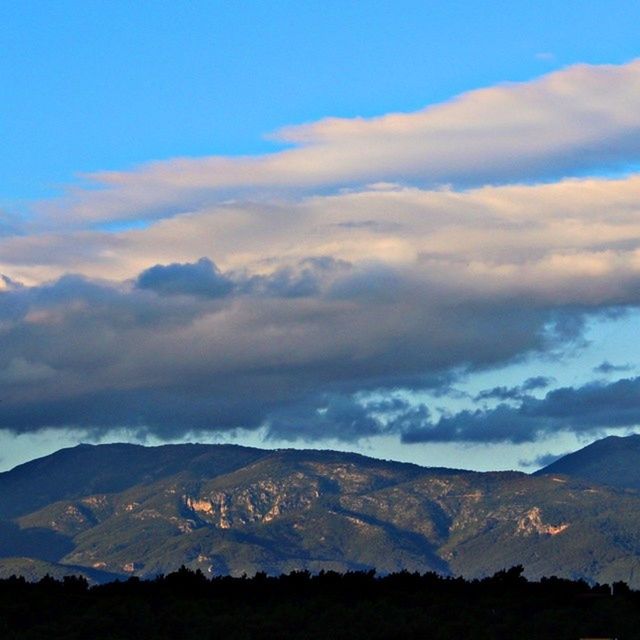 mountain, mountain range, scenics, tranquil scene, tranquility, sky, beauty in nature, landscape, nature, cloud - sky, cloud, idyllic, blue, non-urban scene, outdoors, silhouette, no people, remote, tree, hill