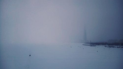 Snow covered landscape against sky