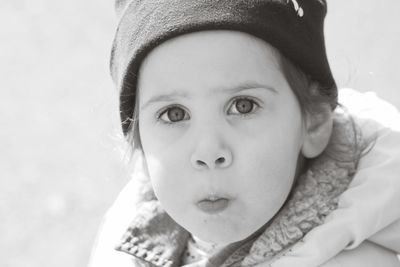 Close-up portrait of girl wearing knit hat