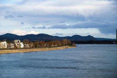 Scenic view of sea by city against sky