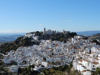 Buildings in town against blue sky