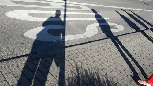 Low section of people standing on tiled floor