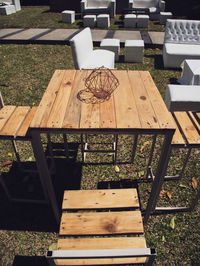 High angle view of empty chairs and table in park