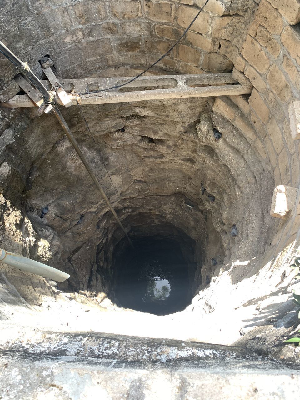 LOW ANGLE VIEW OF OLD TUNNEL WITH BRIDGE IN BACKGROUND