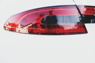 Close-up of red car against white background