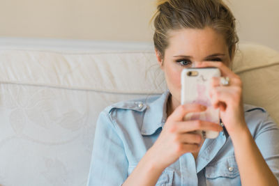 Close-up of young woman using mobile phone