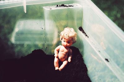 Cute baby boy in toy while looking through window