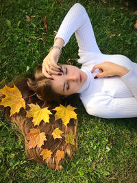 Low section of young woman lying on field