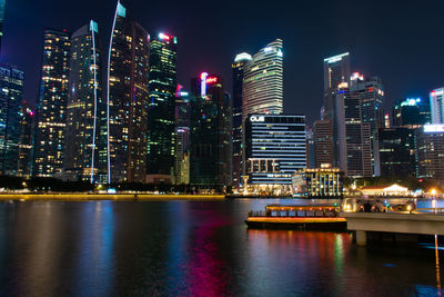 Illuminated modern buildings in city at night