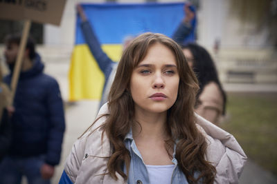 Portrait of young woman standing outdoors