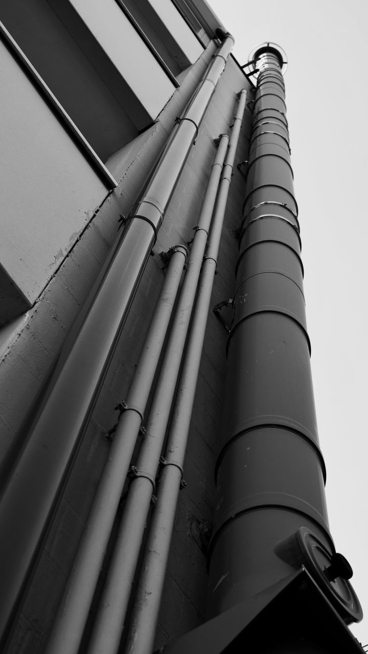 low angle view, pipe - tube, built structure, architecture, day, factory, no people, industry, outdoors, building exterior, water pipe, sky, close-up