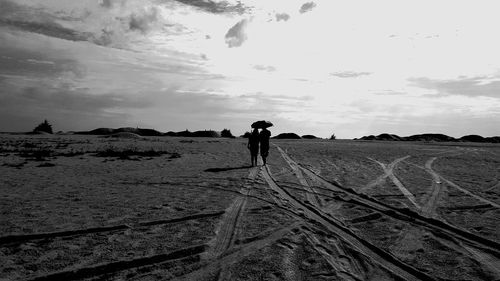 Man standing on field against sky