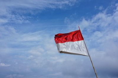 Low angle view of flag against sky