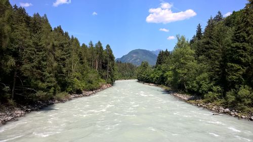 River amidst trees against sky